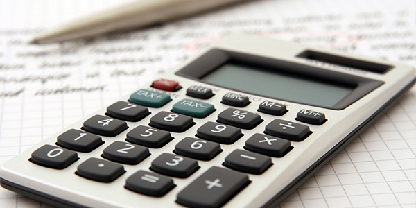 a calculator and a pencil sitting on an open notebook