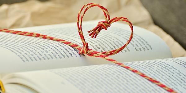 book with string tied in a heart