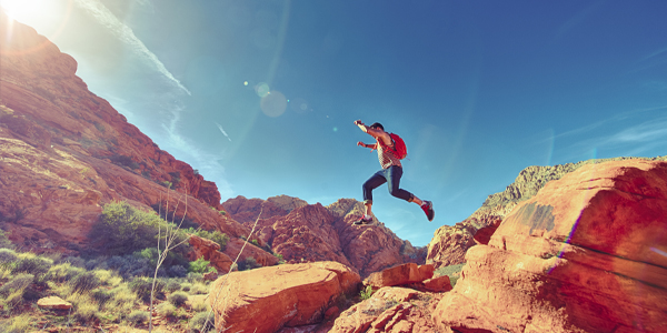 man jumping on a rock