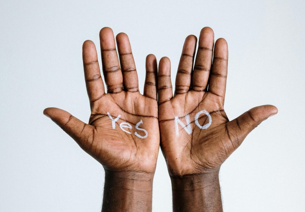 two hands with yes and no written on them